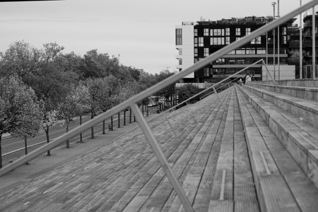 Black and white photo of a wooden staircase in the city center.