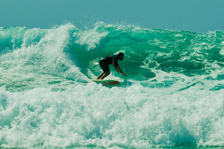 Surfer in action on the ocean wave on a sunny day. Lacanau, France