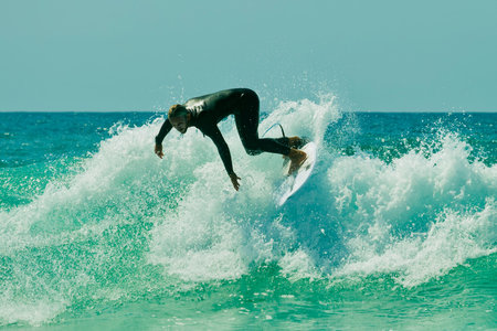 Surfer in action on a beautiful sunny day. Surfing on the ocean wave. Lacanau, France