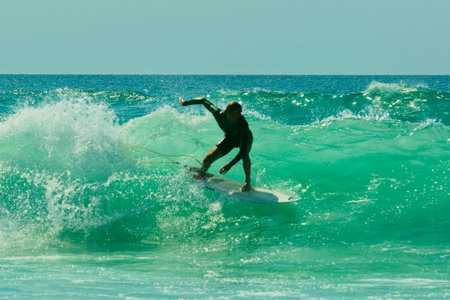 Surfer in action on a beautiful sunny day. Surfing on the ocean wave. Lacanau, France