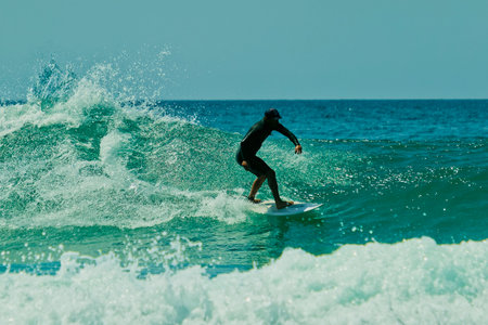 Surfer in action on a beautiful sunny day. Surfing on the ocean wave. Lacanau, Franceの写真素材