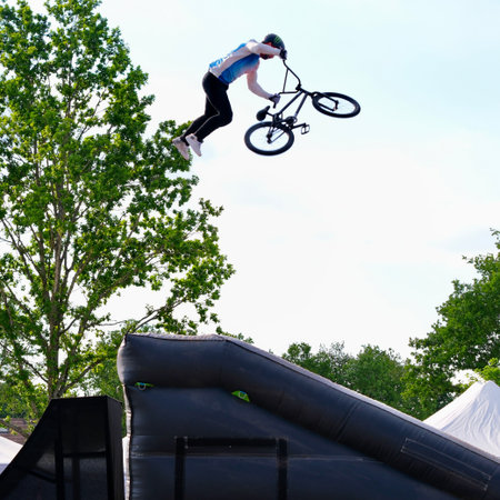 BMX rider performing tricks at a skatepark. Extreme sport. Colline de la revanche, Elancourt, France