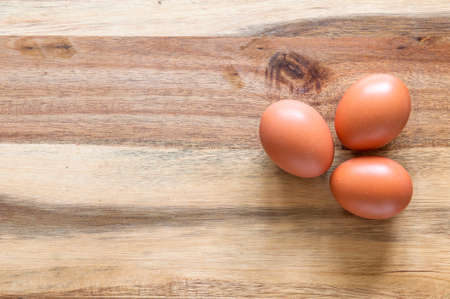 Three eggs on a wooden backgroundの写真素材