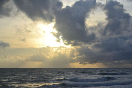 Dramatic sunset over the sea with sun raysの写真素材
