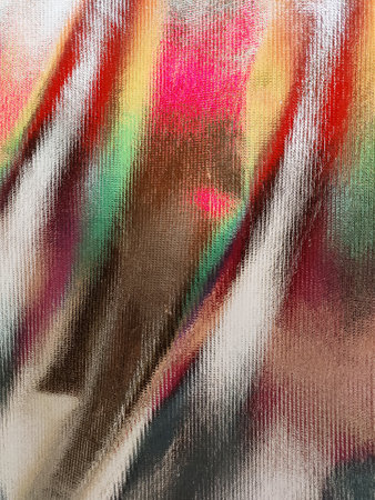 Abstraction of colored glare on a golden surfaceの写真素材