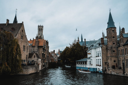 Bruges / Belgium - October 2019: Boat full of tourists on a guided tour through the medieval mysterious city Brugge. UNESCO world heritage site. Popular destination for mystery legend walks and tours.のeditorial素材