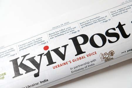 Lviv / Ukraine - March 2020: Close up view of the front page of folded Ukrainian newspaper Kyiv Post on a white desk. Reading and working from home during isolation. Local news coverage in Ukraine.のeditorial素材
