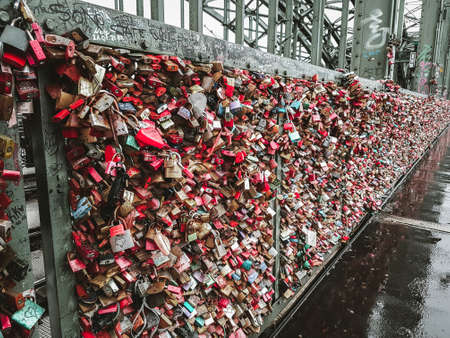 Cologne / Germany - 2018: Romantic Hohenzollern bridge full of padlocks that symbolize love and faithful romantic relationship. Declaration to be together forever, unbreakable partnership. Tradition.のeditorial素材