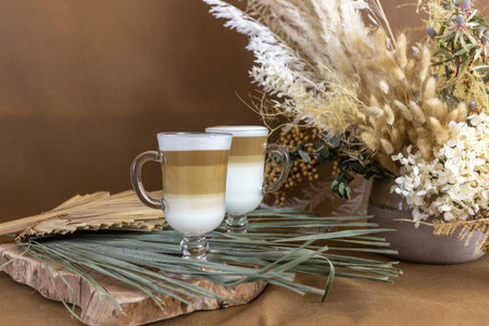 hot chocolate coffee with white foam in a cup on a beige background