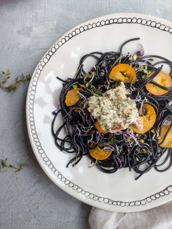 dish with black spaghetti on a gray backgroundの写真素材