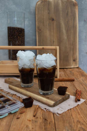 iced coffee with milk in a glass with flowersの写真素材