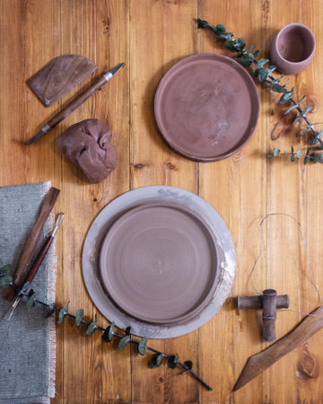 brown clay and pottery tools on a wooden backgroundの写真素材