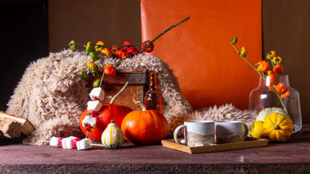 Autumn still life with pumpkins and plaids candles on a wooden backgroundの写真素材