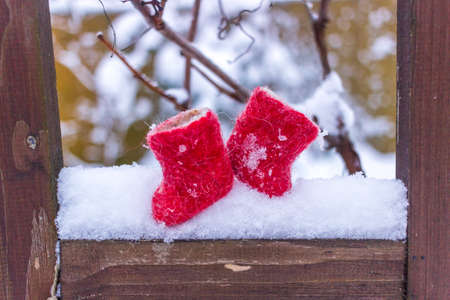 winter still life small red boots on the snowの写真素材