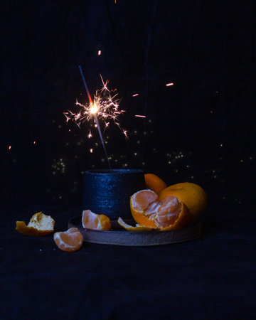 Winter still life with tangerines on a black backgroundの写真素材