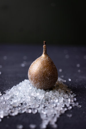 still life with golden pears on a dark backgroundの写真素材