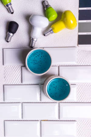 Top view of blue and yellow nail polish in a glass cup.の写真素材