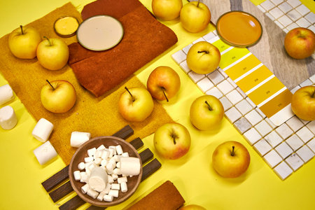Still life with apples and marshmallows on yellow backgroundの写真素材