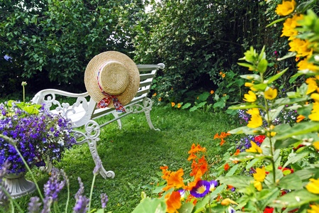 Peacuful summer garden with a hatの写真素材