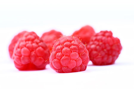 Ripe raspberries on white background 