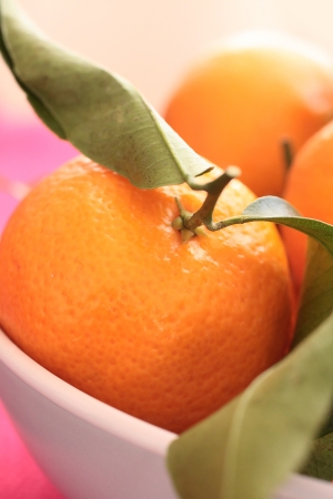 Ripe clementines in the bowl, close up の写真素材