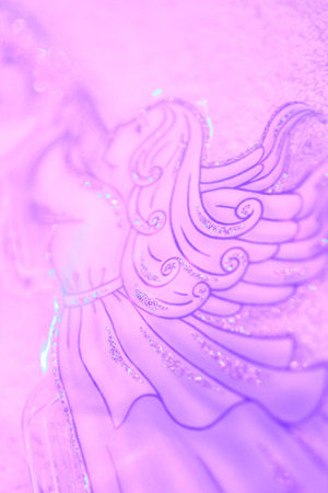 Christmas angel with trumpet soft background in light violetの写真素材