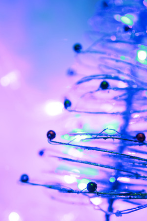 Christmas background of bokeh lights with close up christmas treeの写真素材