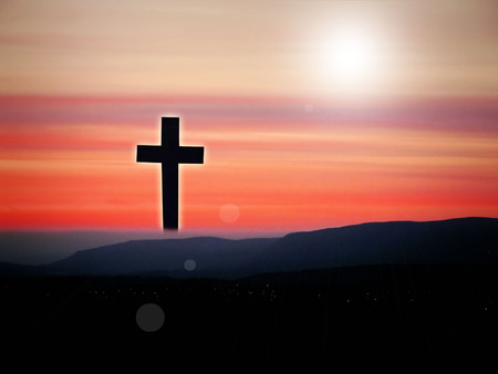 Jesus Christ on the cross in the sunset landscapeの写真素材