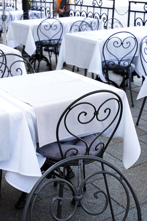Stylish metal chair and tables at the restaurantの写真素材