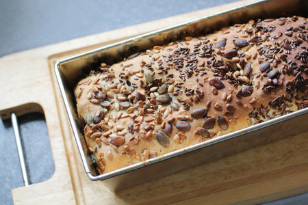 Organic home made bread freshly baked with lots of seeds close up