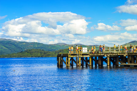 People having fun on a sunny day at the Luss Pier, Loch Lomond, Argylle and bute, Scotlandのeditorial素材