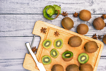 Kiwi fruit cut in slices on wooden cutting boardの写真素材