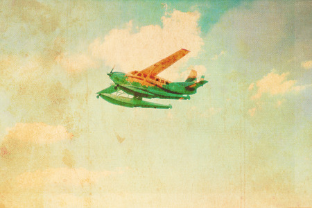 Vintage plane on the old, stained paper backgroundの写真素材