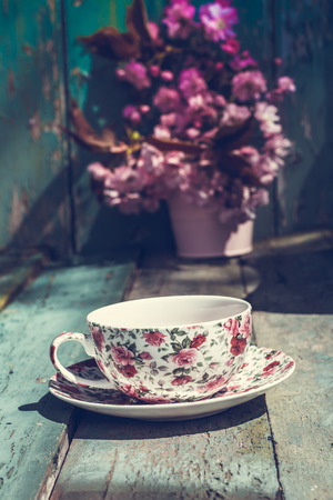 Beautiful, English, vintage teacup with Japanese cherry tree blossoms, close uptの写真素材