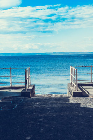 A white fence at the beach with the view on the seaの写真素材