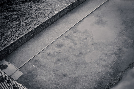 Abstract background with water and asphalt in black and whiteの写真素材