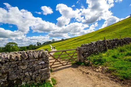 Old, stone wall on the way to Malham Cove Yorkshire Dales National Park Tourist Attraction, England, UKの写真素材