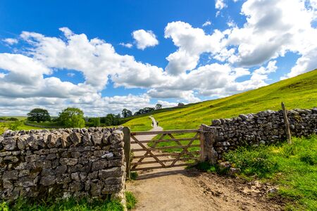 Old, stone wall on the way to Malham Cove Yorkshire Dales National Park Tourist Attraction, England, UKの写真素材
