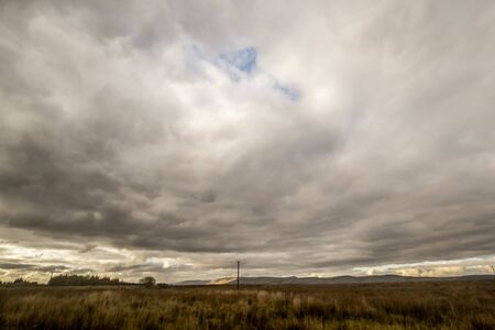 Fantasy rural landscape with fields and blurry skyの写真素材