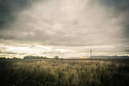 Fantasy rural landscape with fields and blurry skyの写真素材