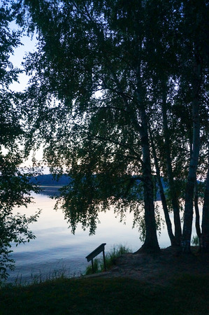 The evening sunsets on the river silhoette of treeの写真素材