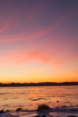 Ice on river in frosty winter sunsetの写真素材