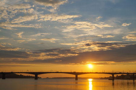 Beautiful orange sunset over the bridge on the Volga river in Kostromaの写真素材