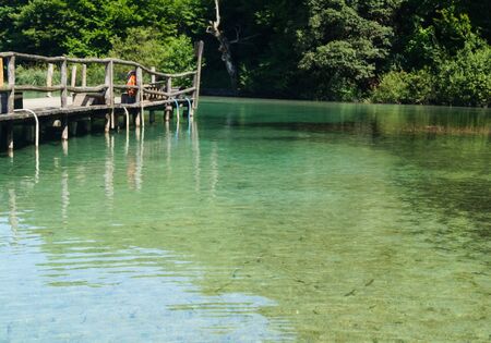 Beautiful blue green water on a sunny day in the lake at Plitviceの写真素材