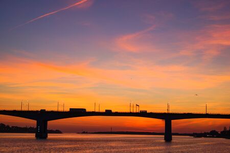 Beautiful orange and pink sunset on Volga river view of bridge Kostroma, Russiaの写真素材