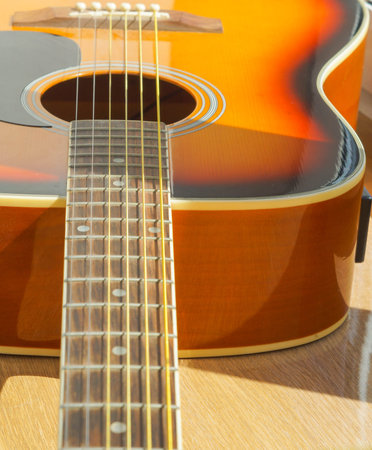 detail view of the sound hole and strings of an acoustic guitar vertical