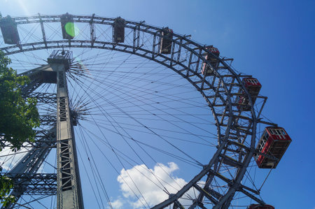 Ferris wheel blue sky clouds and sunの写真素材
