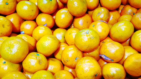 Fresh mandarin oranges fruit or tangerines, as background closeupの写真素材