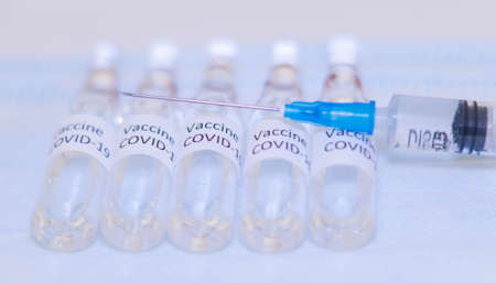 ampoules with Covid-19 vaccine on a laboratory on the table, syringeの写真素材