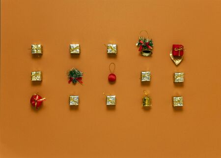 bright orange background, in the center different Christmas balls laid out in exactly three rows, top view, horizontal frame, copy spaceの写真素材